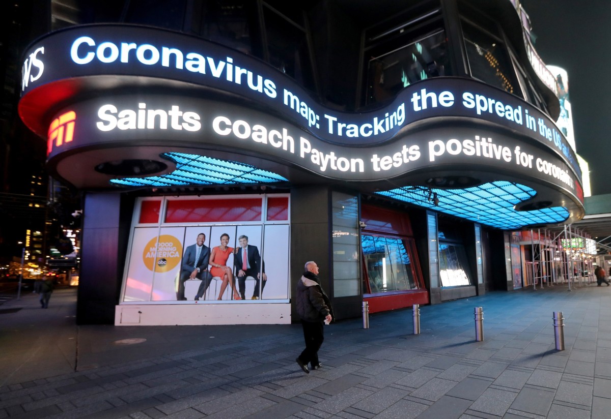 March 19, 2020: New York, NY, USA: A man walks below announced the news that a New Orleans Saints coach, Sean Payton tested positive for coronavirus.  Mandatory Credit Kevin Wexler